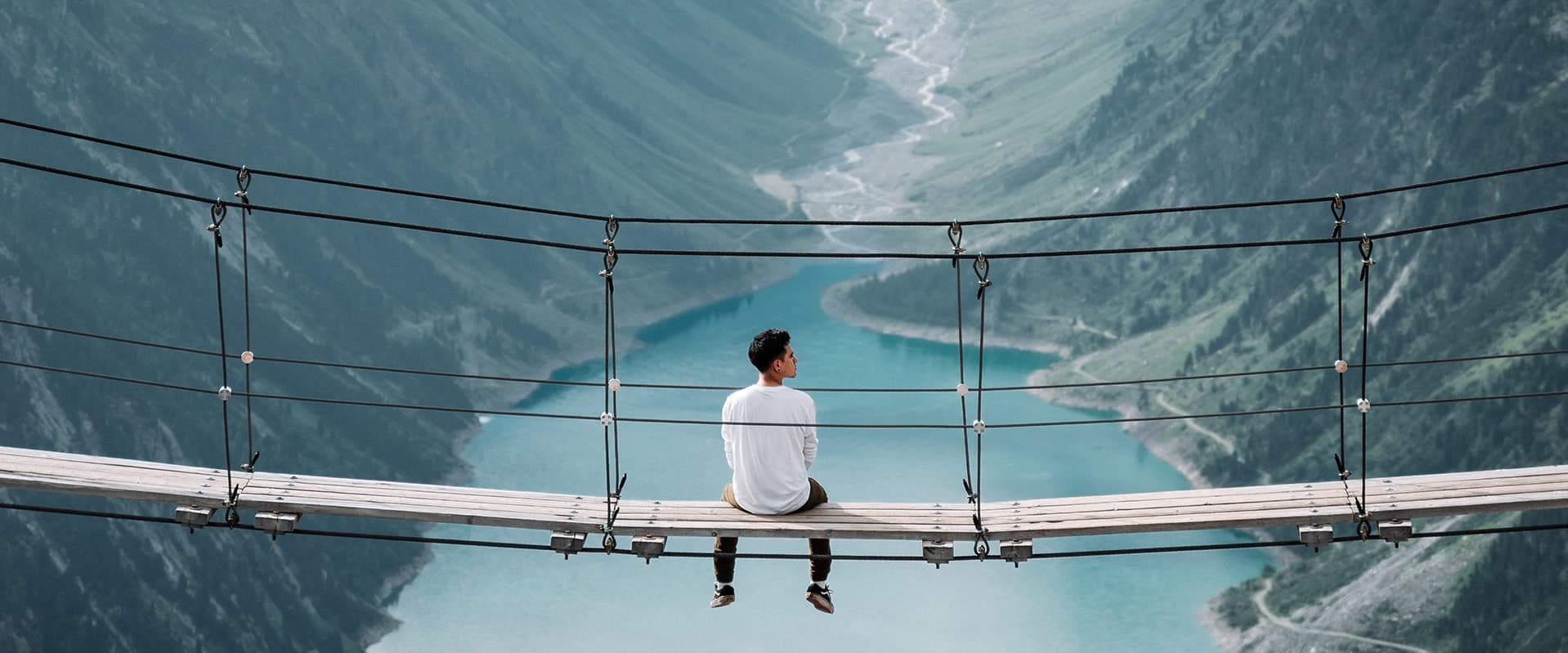 Man on suspension bridge