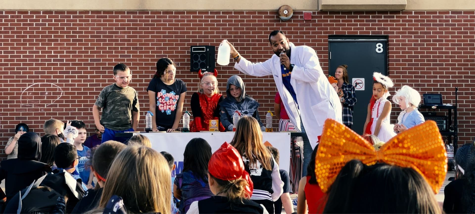 Roy singing and leading a demonstration at a STEM outreach event