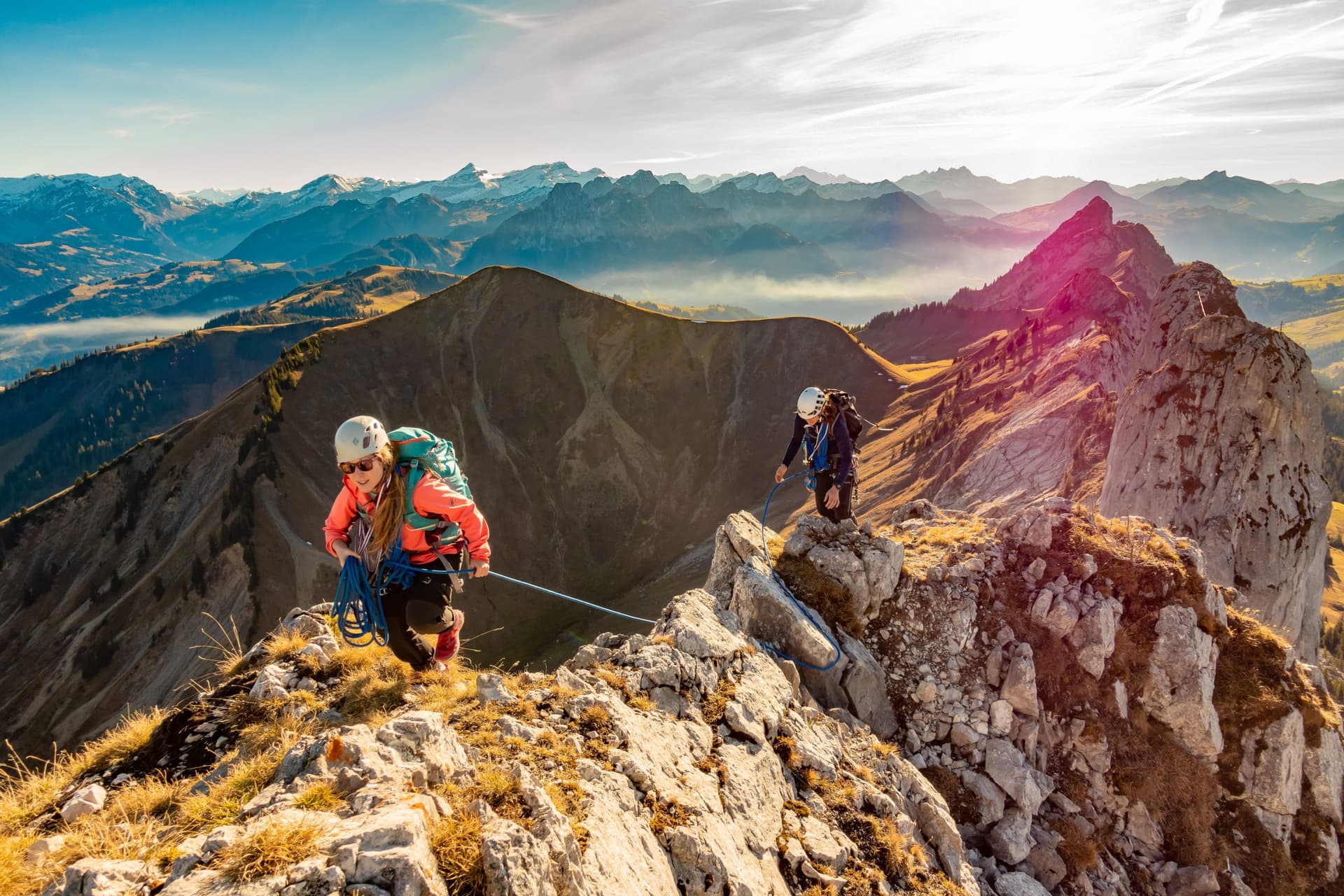 Two people climbing a mountain