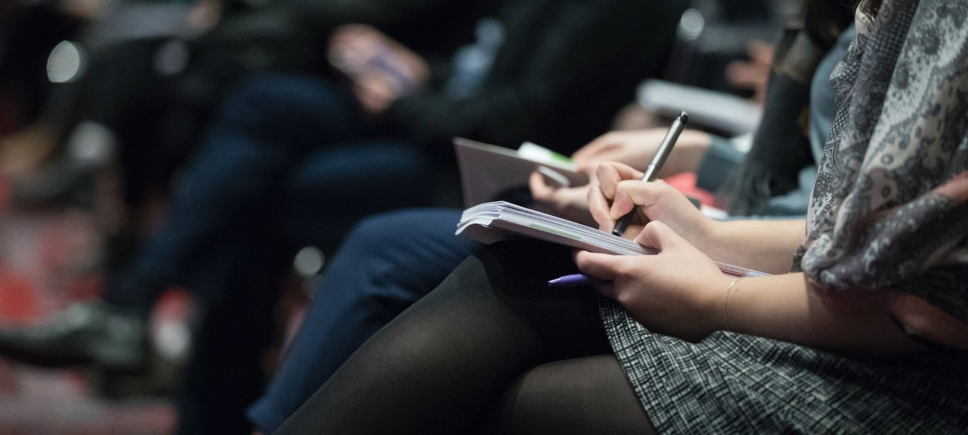 A journalist taking notes in a notebook