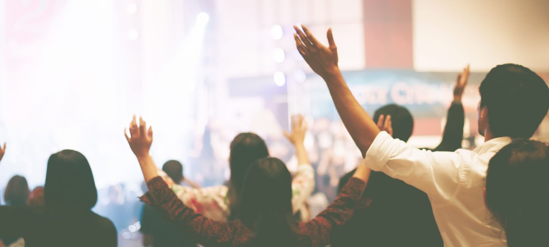 People lifting up their hands in a church service