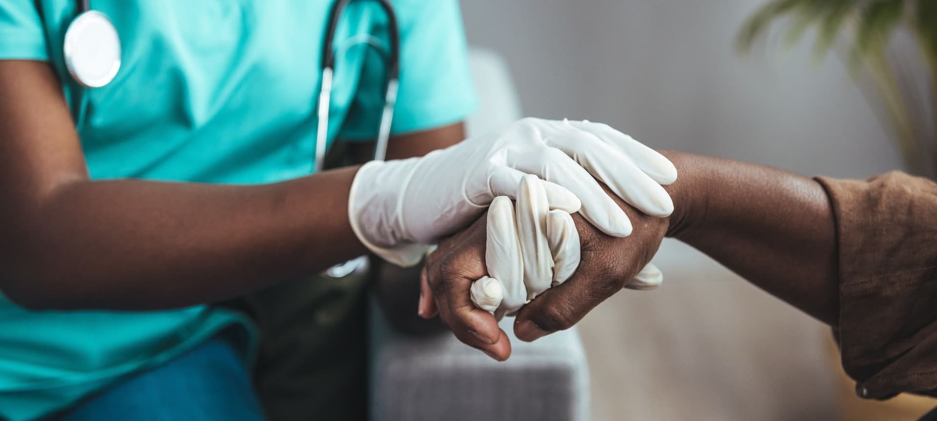 Doctor holding patient's hand in health care setting