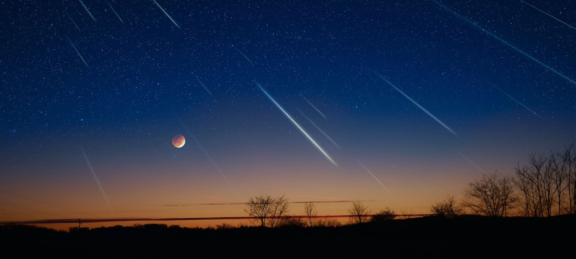 Meteors falling in a night sky dimly lit by moon and sunset in horizon