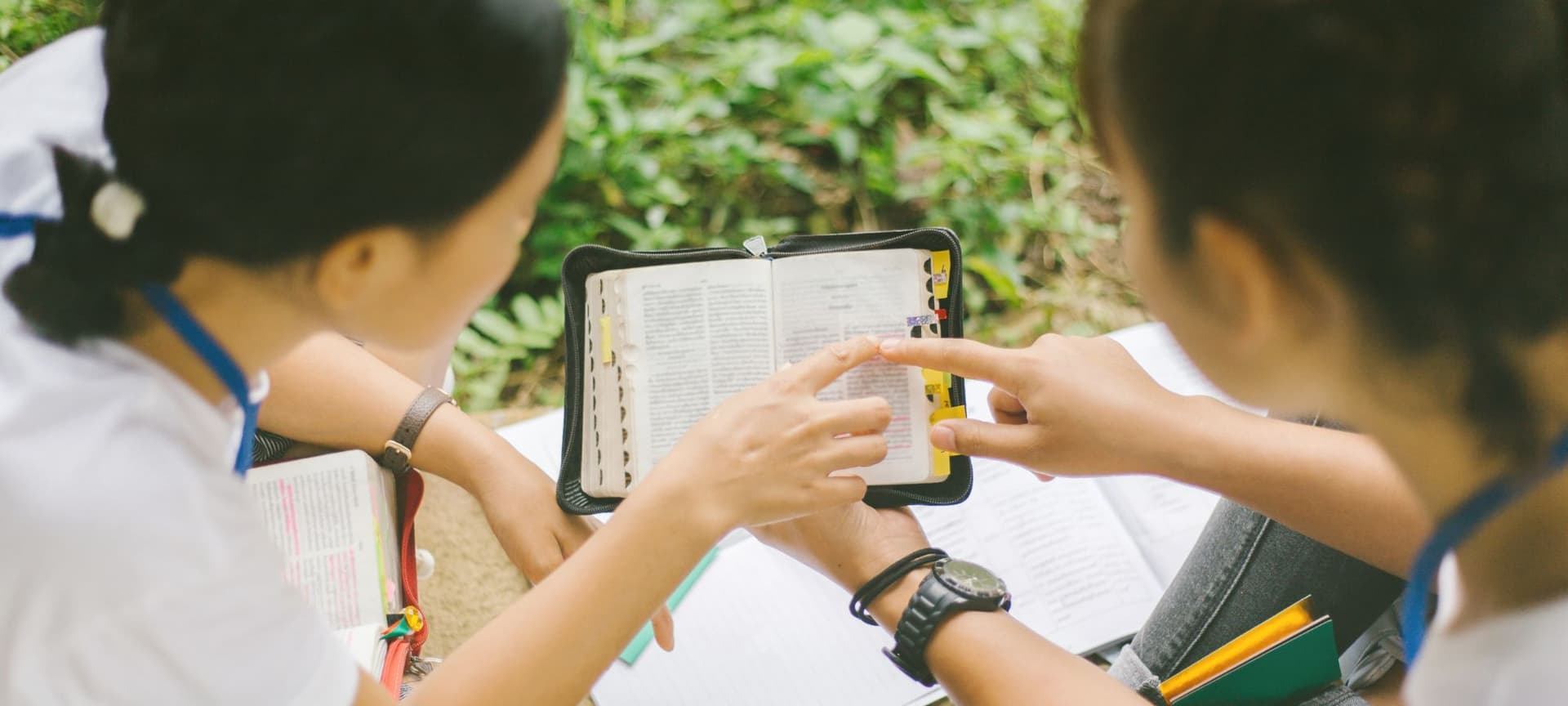 Two young adults reading and studying the bible together