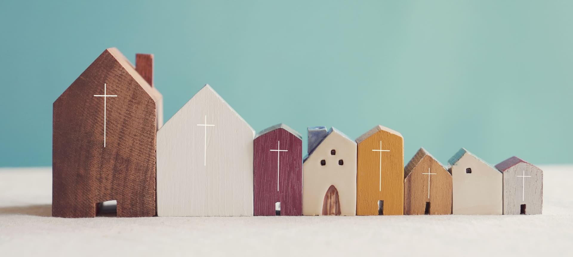 A variety of wooden churches of various colors arranged from largest to smallest