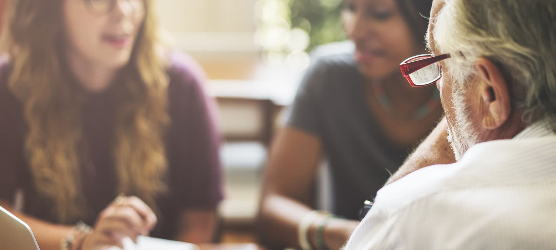 Two students talking with a professor
