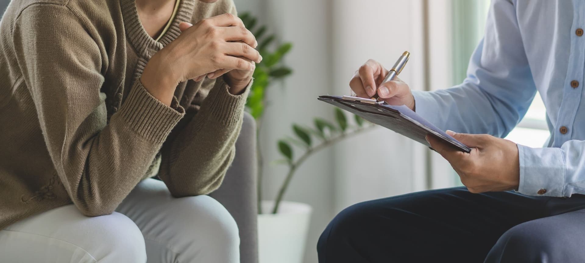 Close-up of mental health professional with client talking together