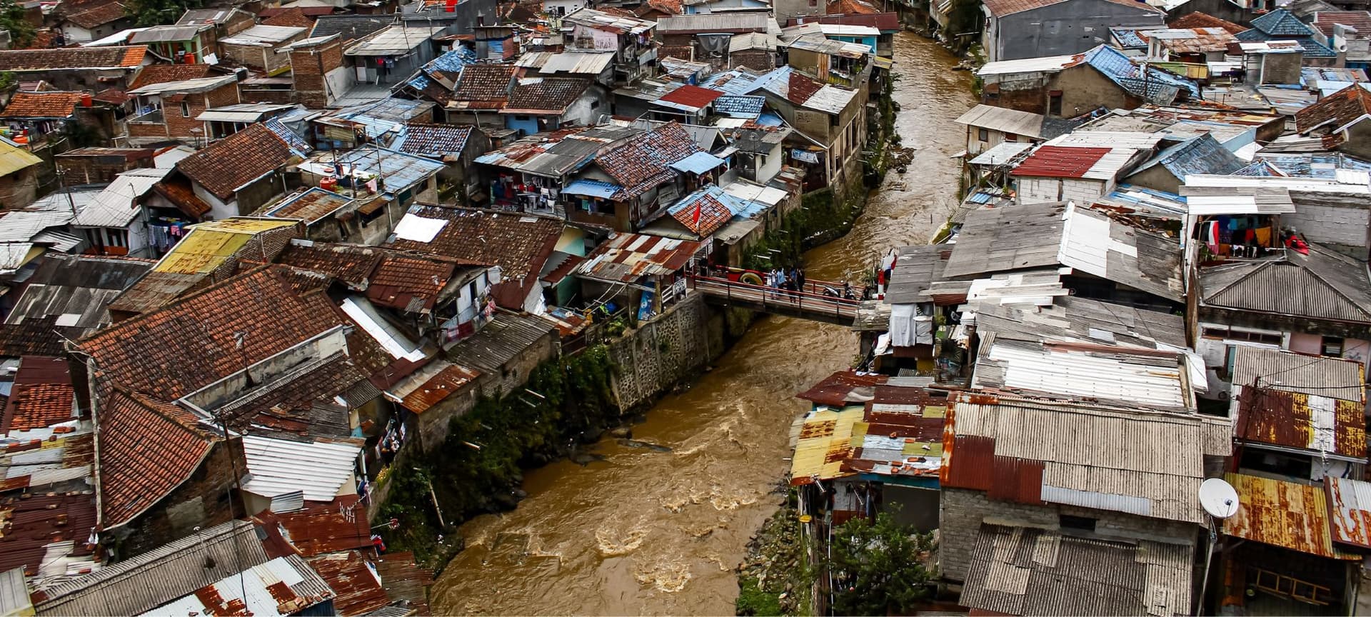 Houses in the slums surrounding a polluted river