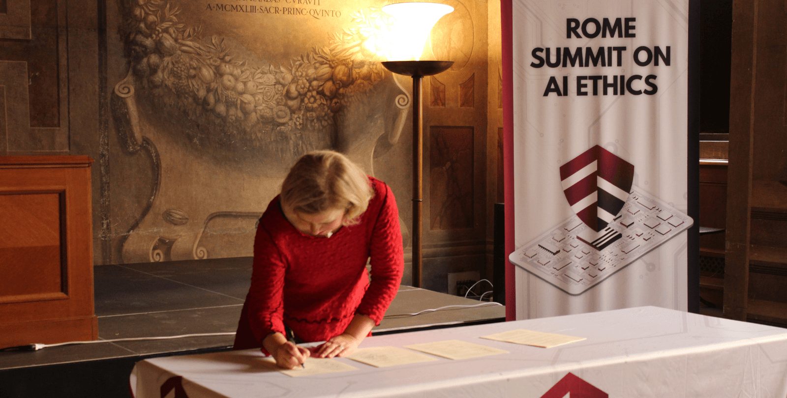 BioLogos President Kristine Torjesen signs the Joint Statement on Ethics and Artificial Intelligence in Rome.