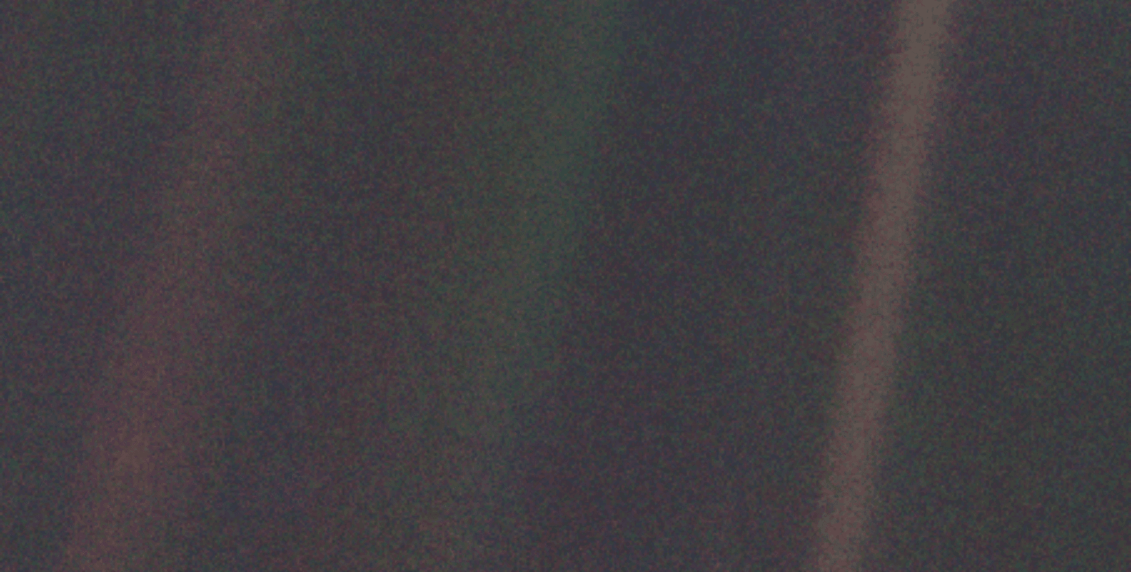 A portion of the "Pale Blue Dot" image taken by Voyager I. The image, taken nearly four billion miles away, shows Earth as a tiny dot against the vastness of space.