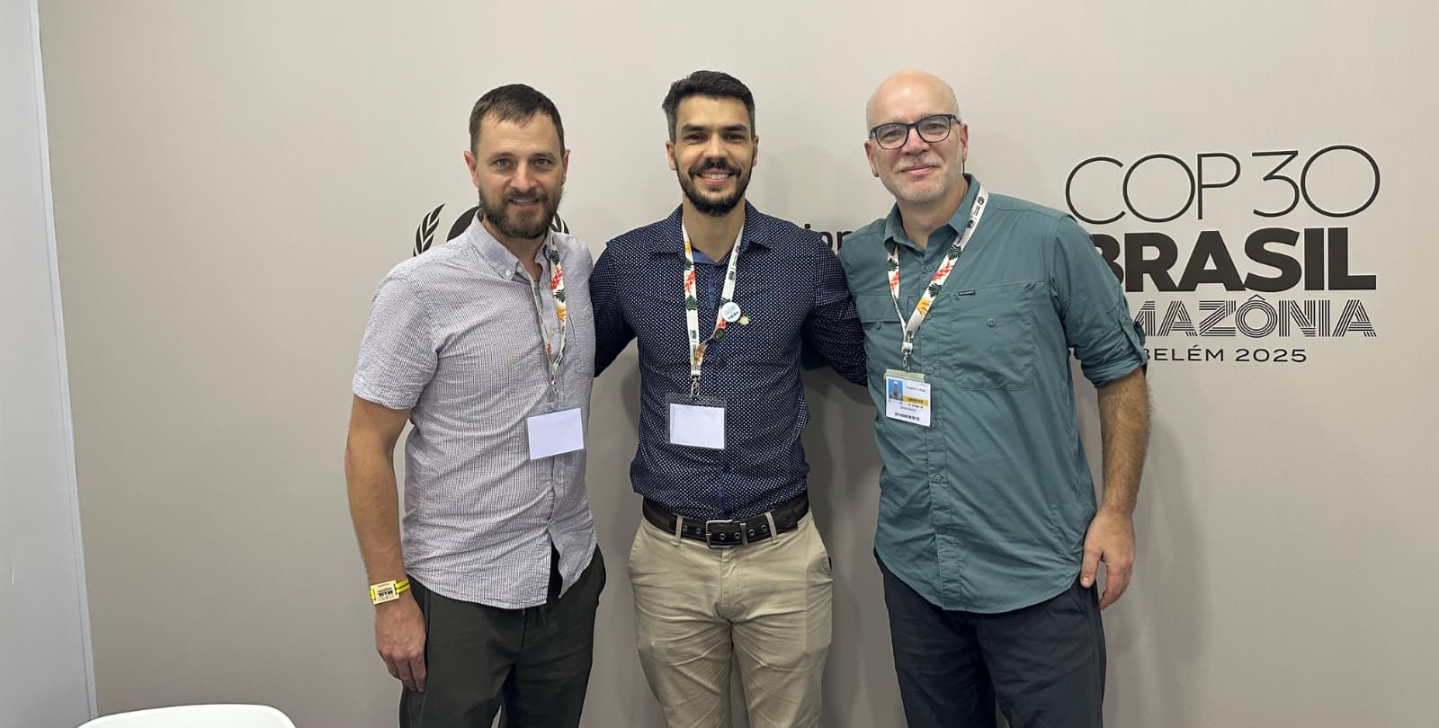 BioLogos' Jim Stump and Colin Hoogerwerf pose in front of a wall that reads "COP30 Brasil Amazonia."