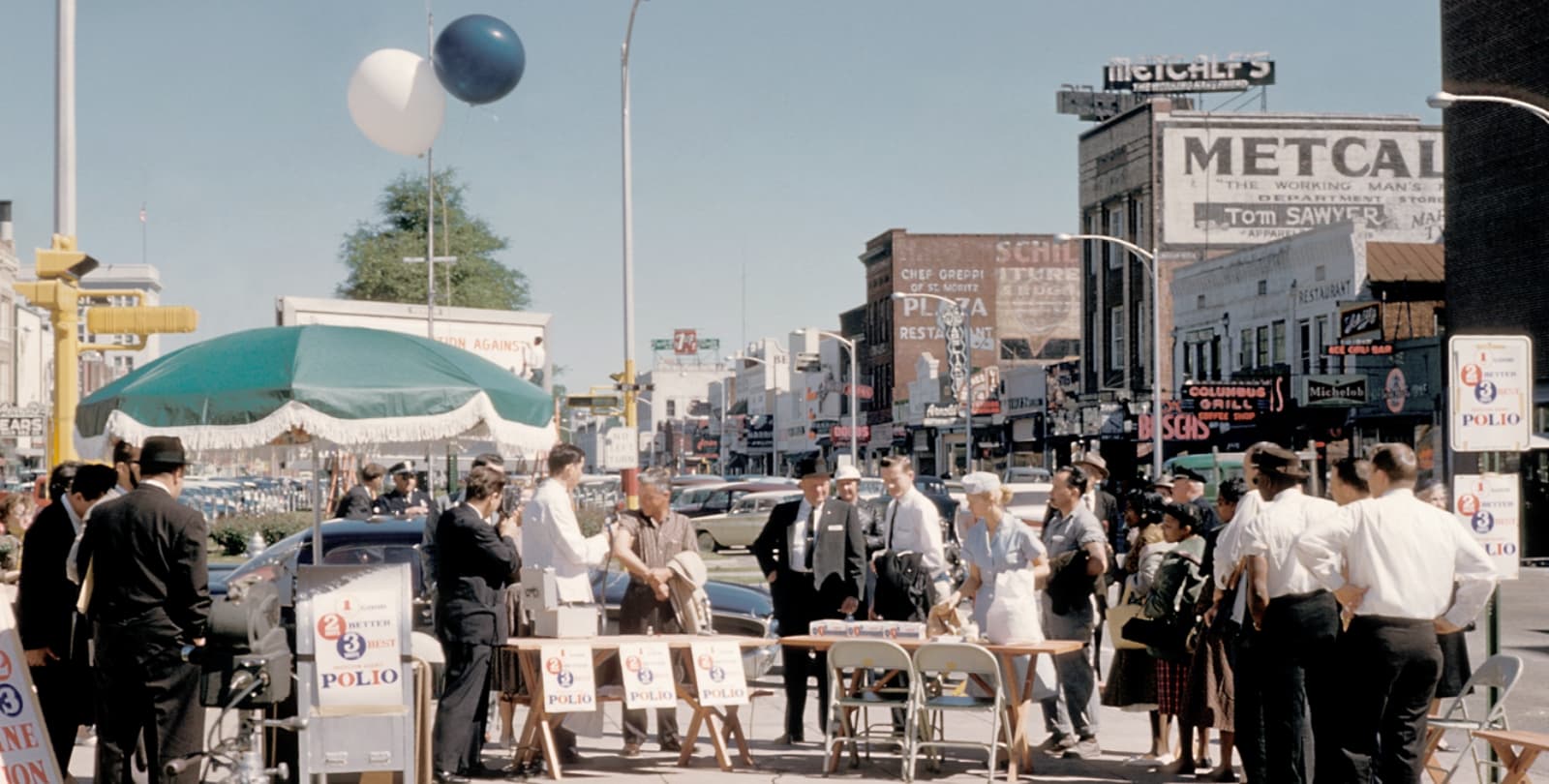 A crowd of people wait in line to receive the polio vaccine.
