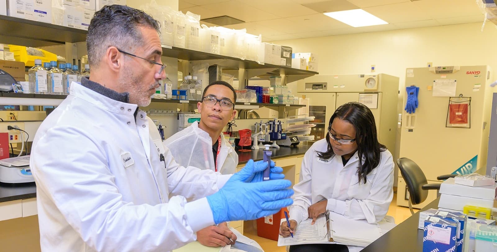 A group of scientists work in a lab together.