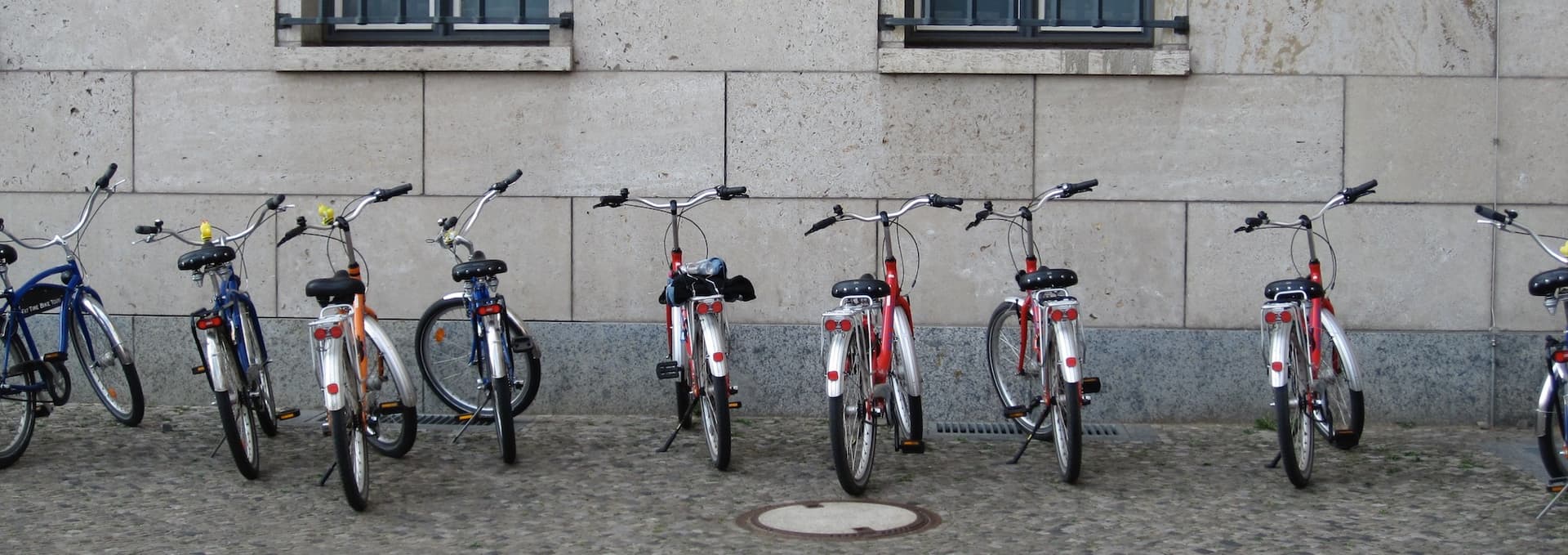 bikes in a row against a building