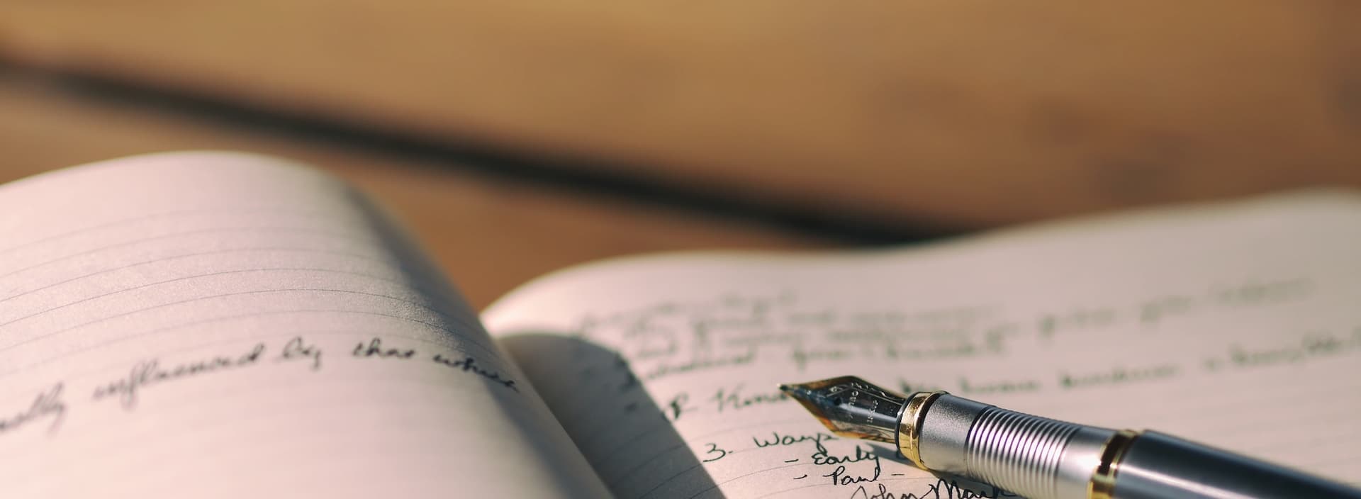 calligraphy pen resting on a journal