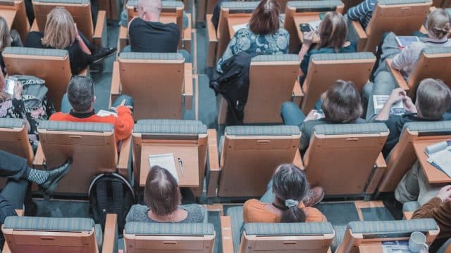students in rows in classroom auditorium