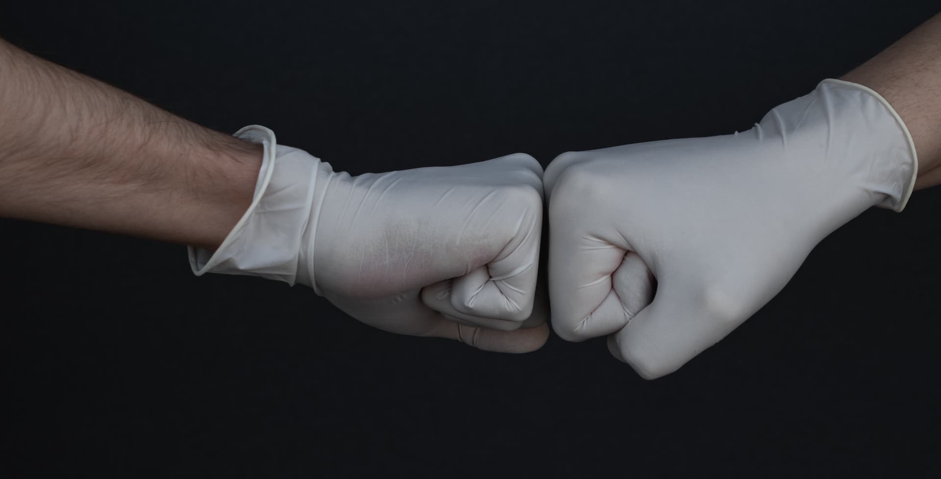 gloved hand fist bump