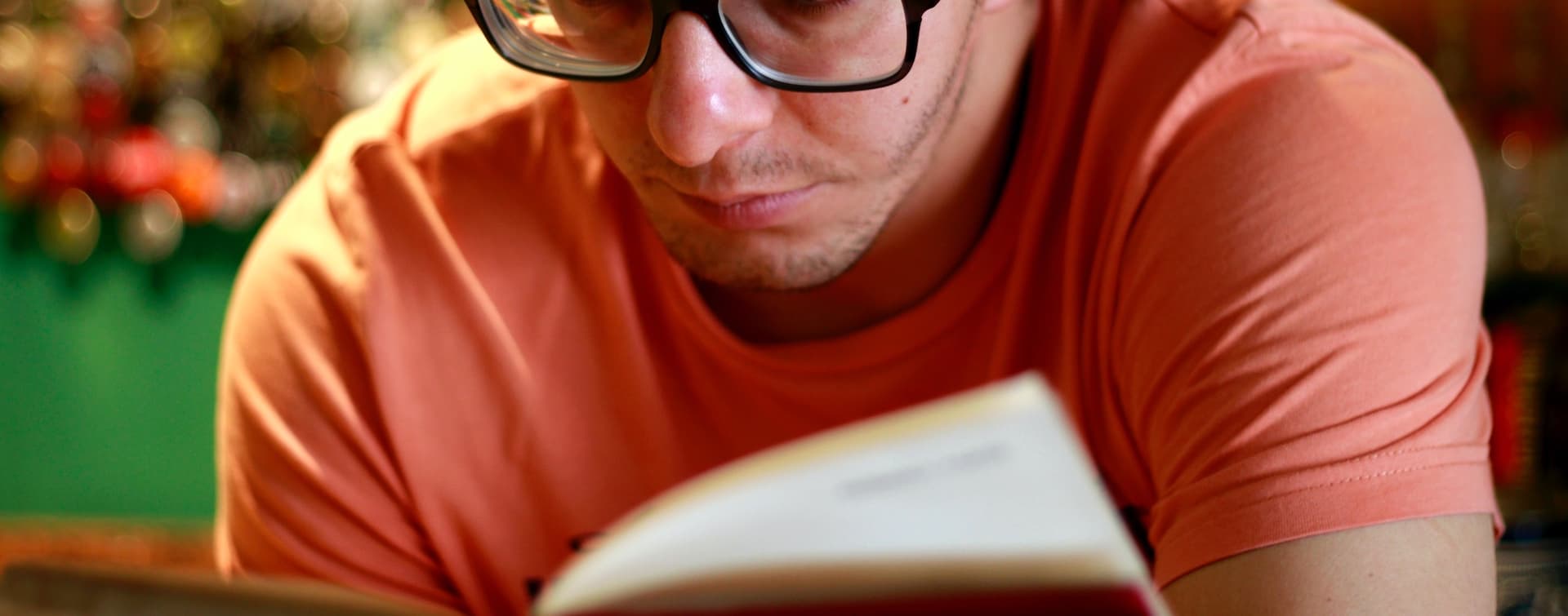 man in glasses reading a book