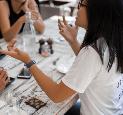 Woman conversing with friends at a table