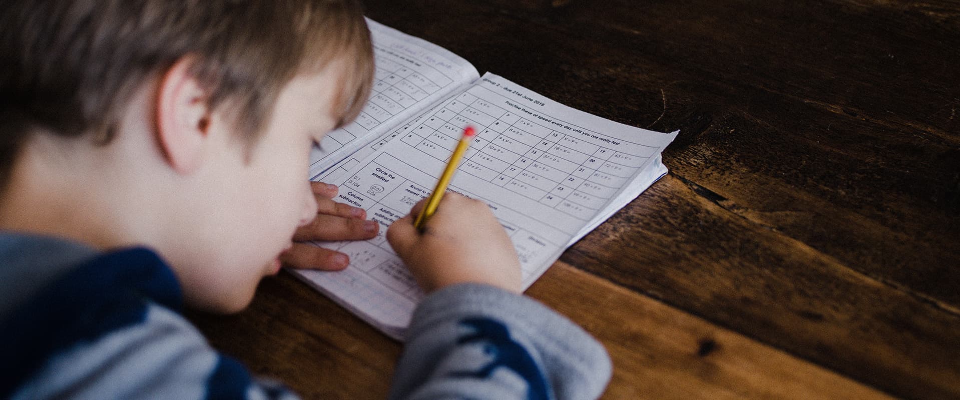 Boy doing school work at table