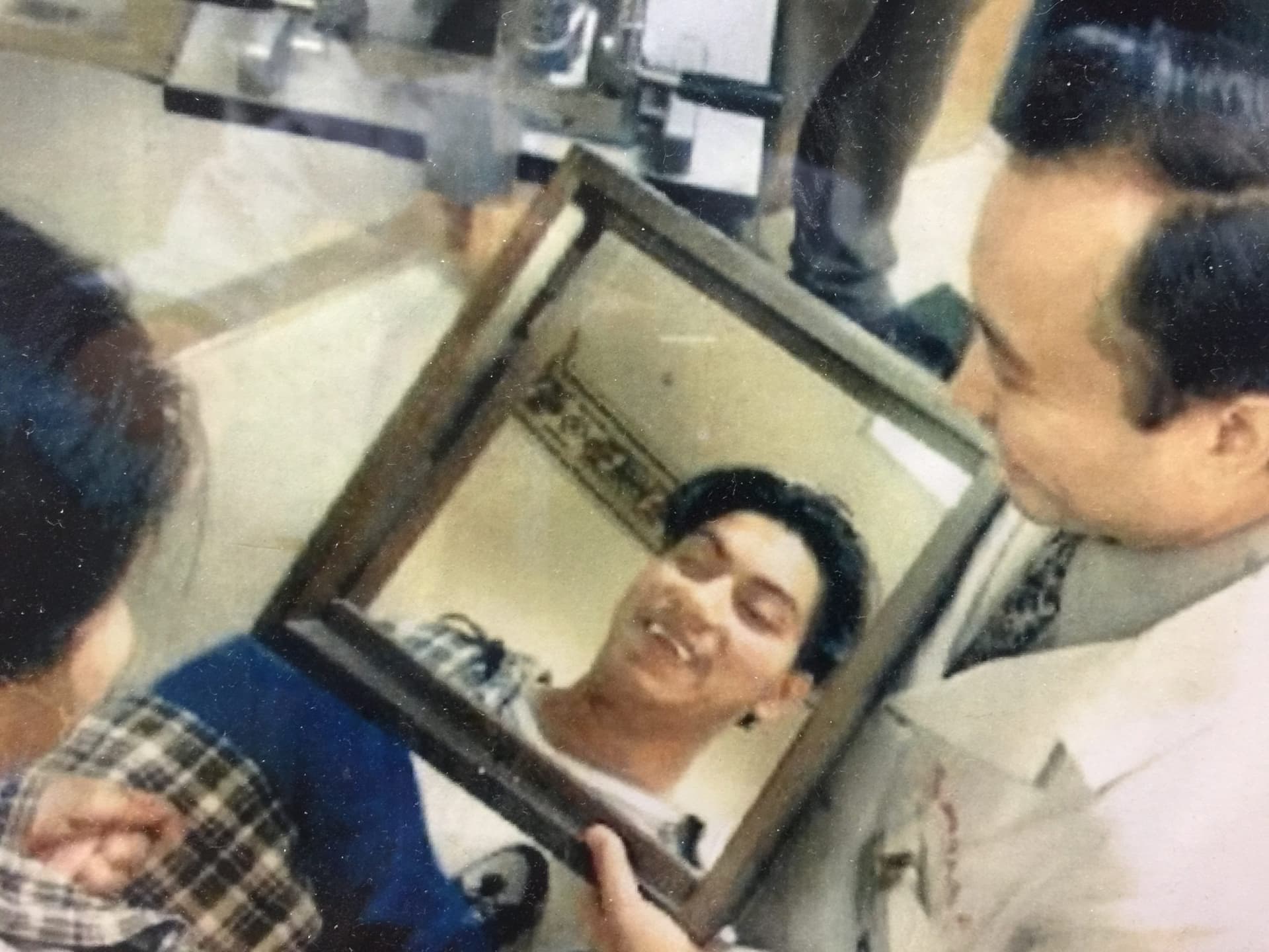 Dr. Wang with then 17 year old Francisco as he looks in a mirror and sees himself for the first time in years.