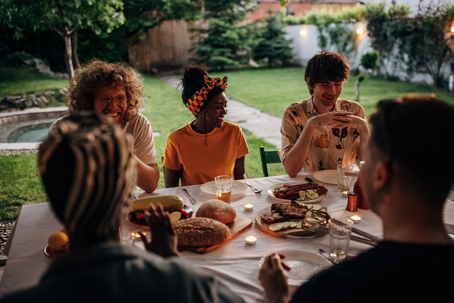 People sitting at a table outside sharing a meal