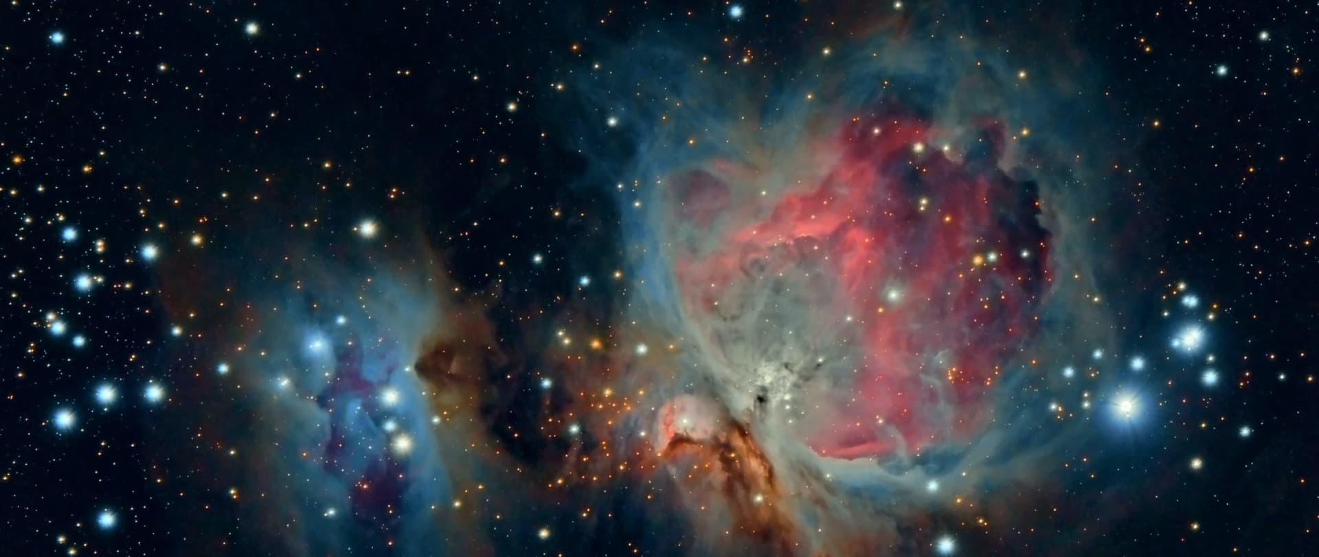 colorful image of space studded with stars that are part of the Orion Constellation and the "Running Man" nebulae