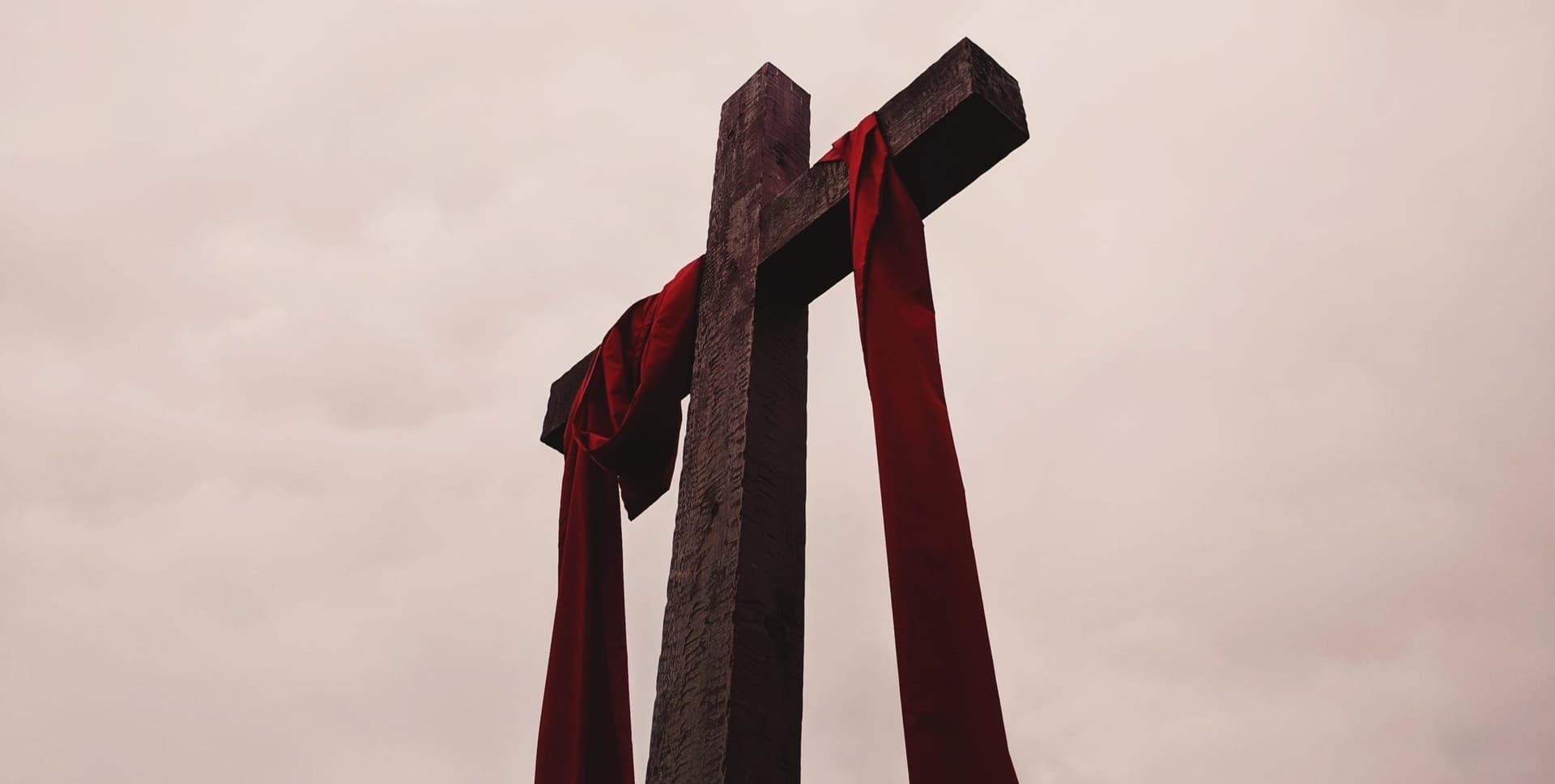 Cross with red mantle draped over it