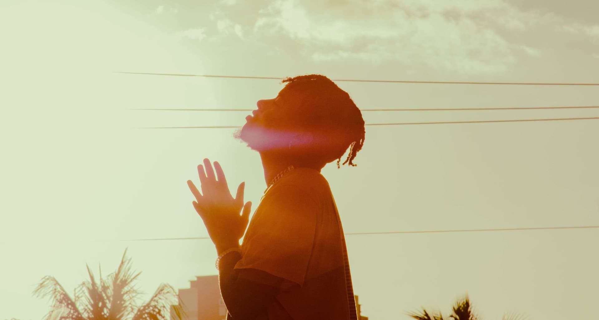 Person standing in contemplative and prayerful pose