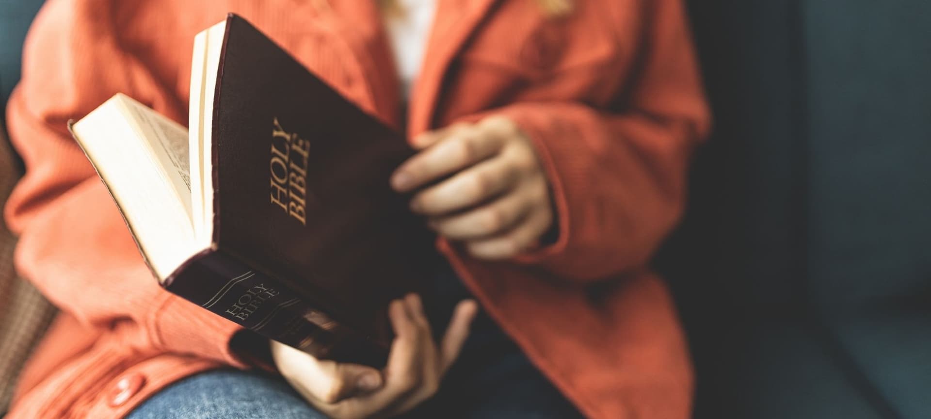 Closeup of a person's hands opening a Bible