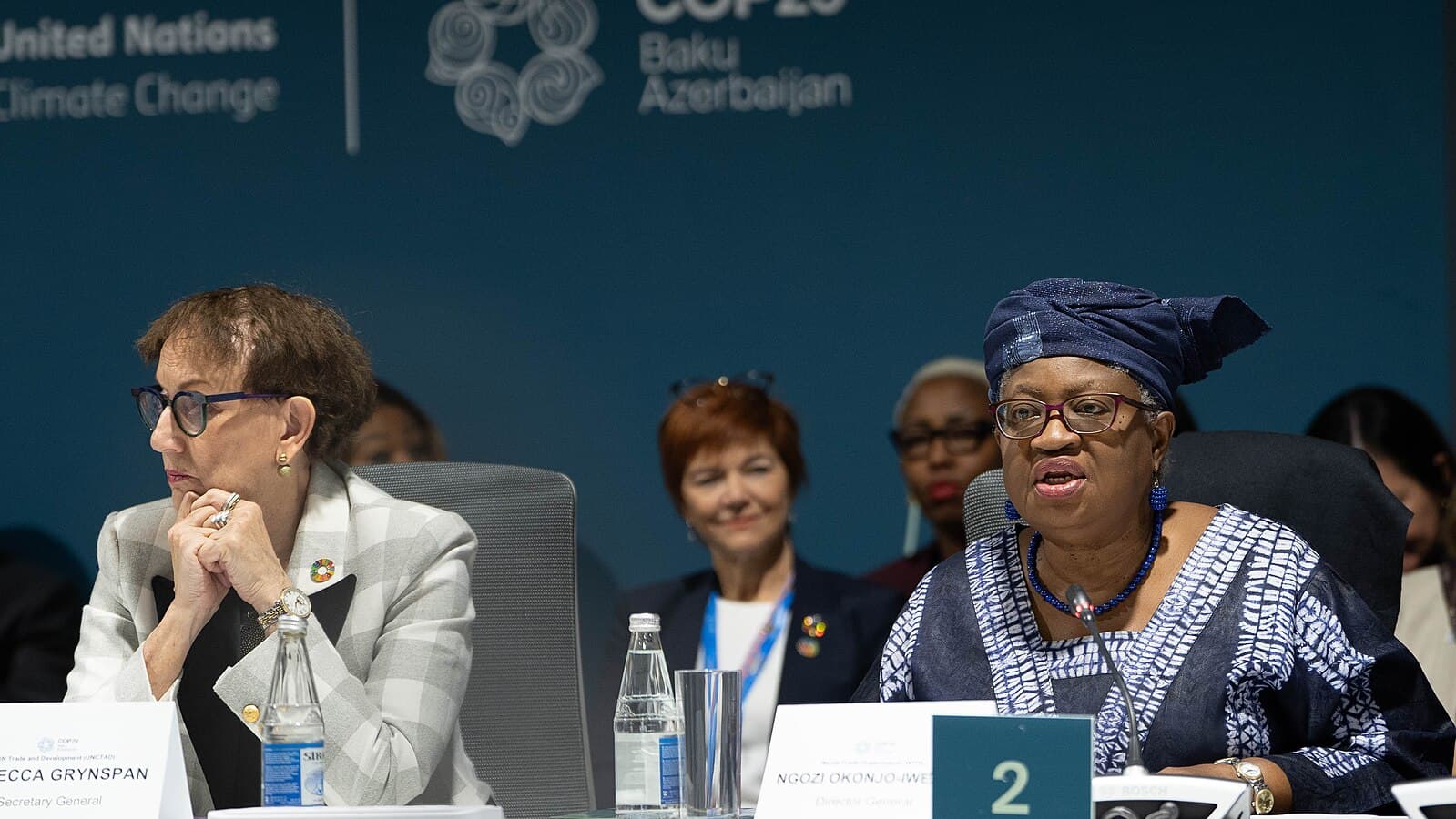 Photo of a panel meeting of the Baku Initiative for Climate Finance, Investment and Trade at COP29. Two women sit on the panel, with a row of people sitting behind them.