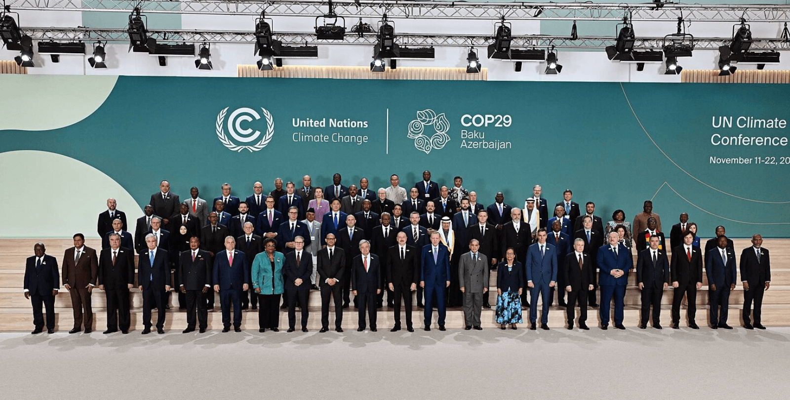 The Opening Ceremony of COP29. A large group of dignitaries stand on a series of risers in front of a backdrop reading "United Nations Climate Change" and "COP29 Baku Azerbaijan".