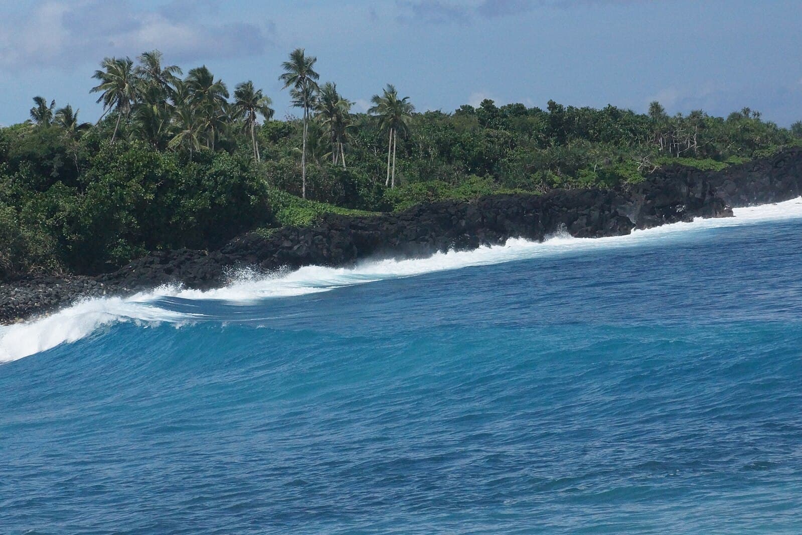 Waves crash on a shore in Samoa.