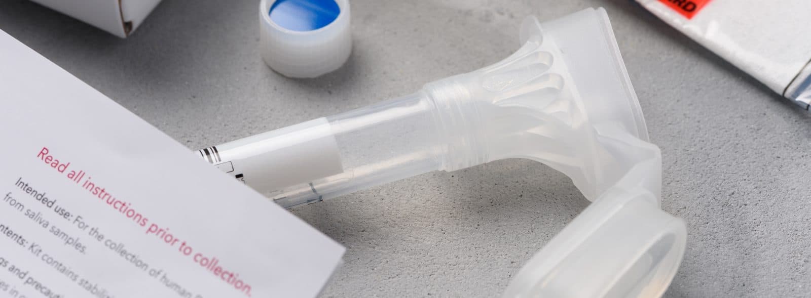 A DNA collection tube and instruction manual.